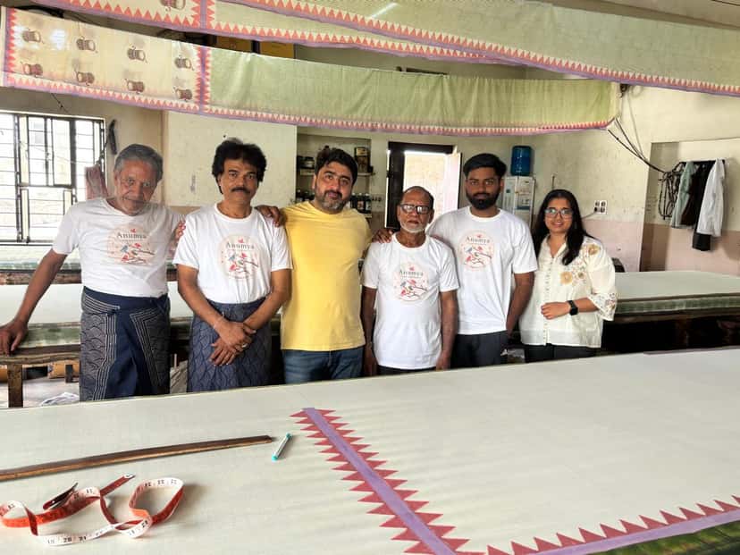 The Anumya team with their block printing artisans at the printing tables